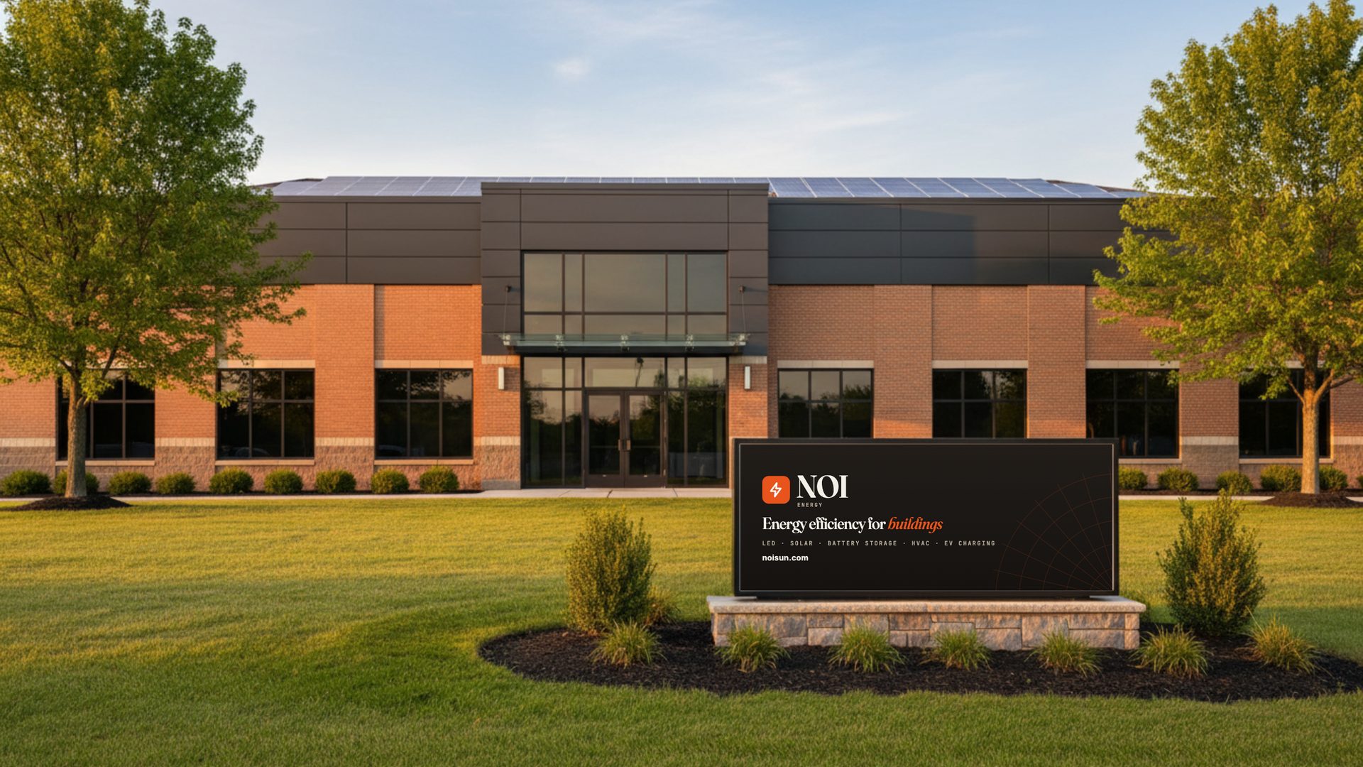 Commercial building with rooftop solar and an NOI Energy sign out front