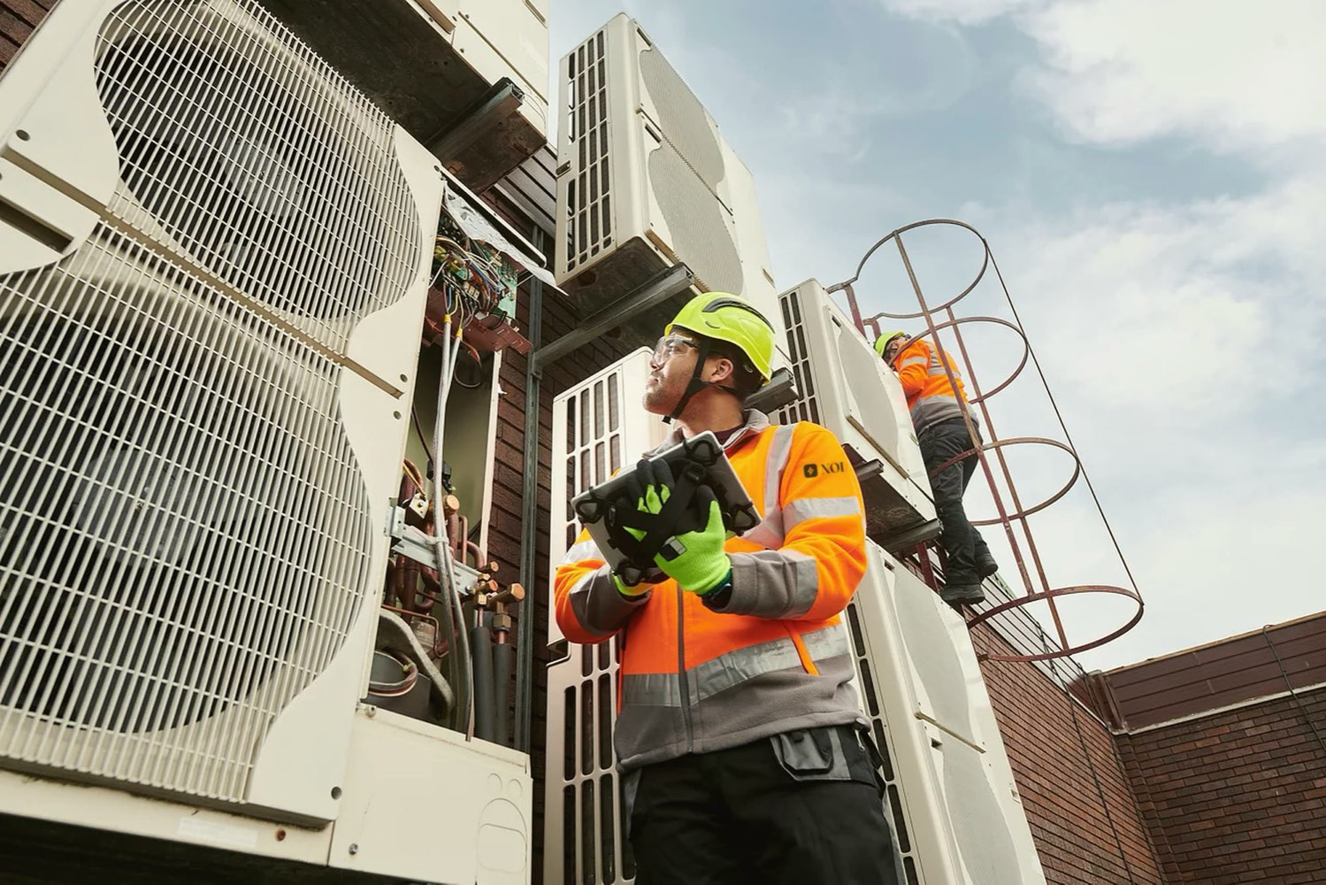 NOI inspecting rooftop HVAC equipment during a building energy assessment